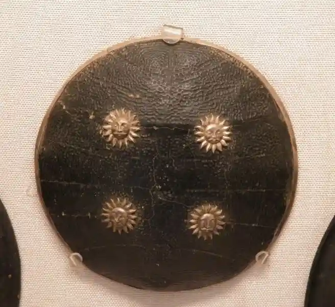 Shield with four suns with faces